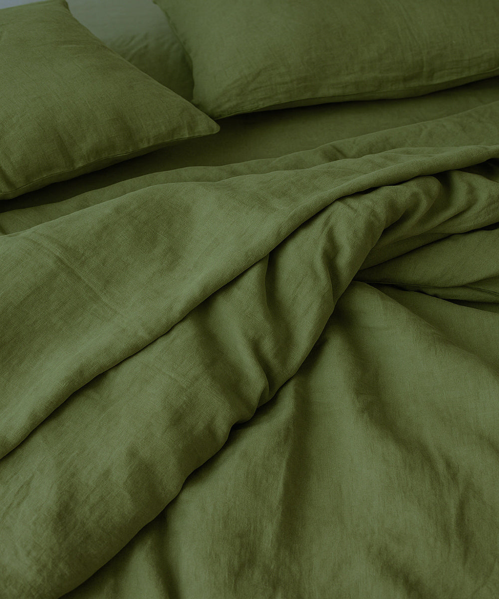 Green bedding set with two pillows on a bed