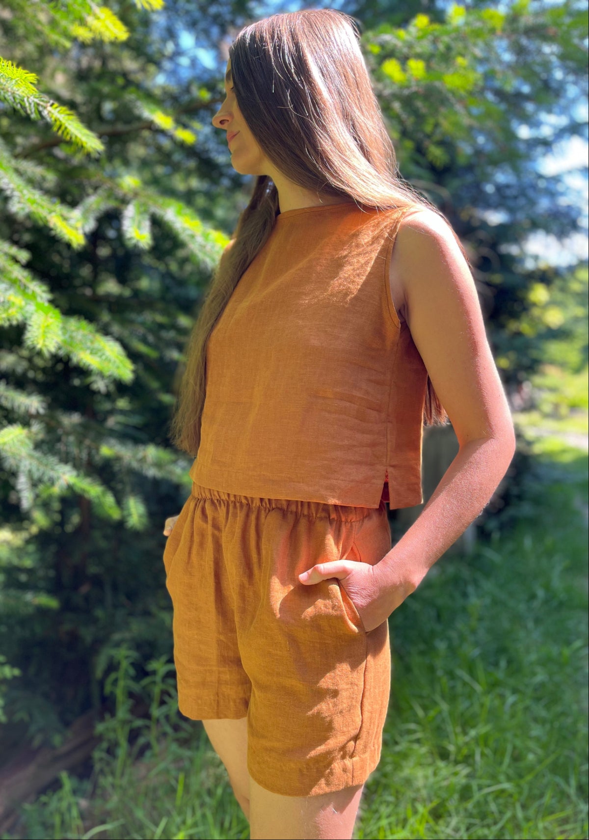 A woman wearing a sleeveless linen top 
