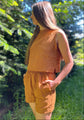 A woman wearing a sleeveless linen top 