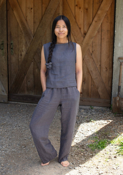 A woman wearing dark grey linen lounge pants