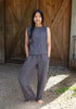 A woman wearing dark grey linen lounge pants