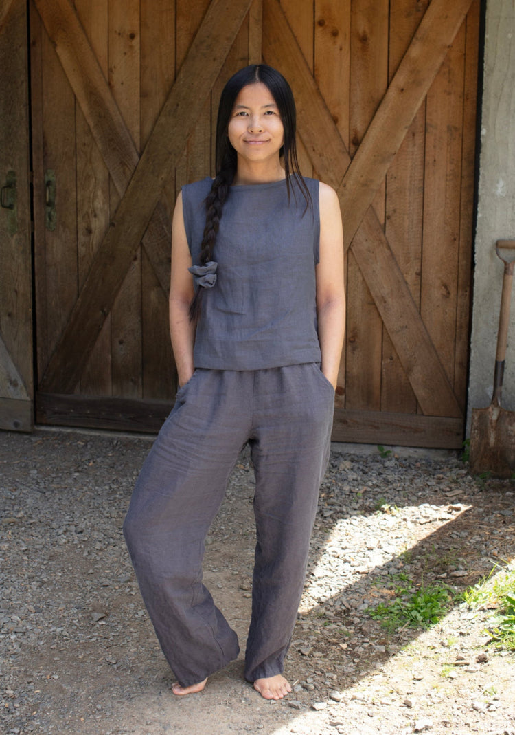 A woman wearing dark grey linen lounge pants